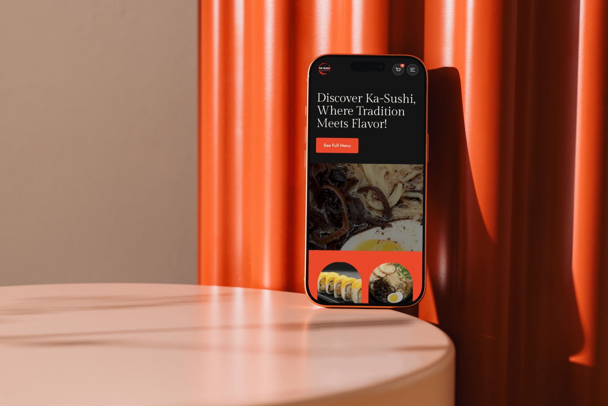 The Ka-Sushi mobile homepage on an iPhone leaning against an orange wall